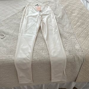White leather like legging/pant. Slight flare with slit